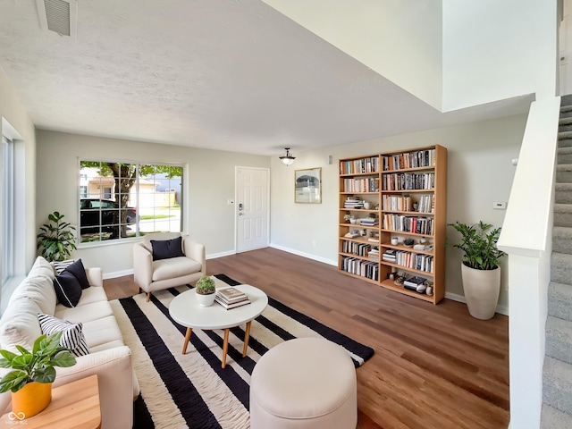 6628 Dunsdin Dr, Plainfield, IN 46168 - living area featuring baseboards, stairs, wood finished floors, and visible vents