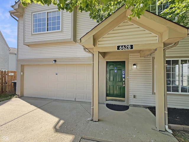 6628 Dunsdin Dr, Plainfield, IN 46168 - doorway to property featuring fence, an attached garage, and driveway