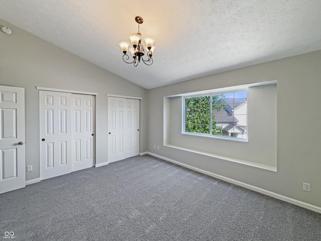 6628 Dunsdin Dr, Plainfield, IN 46168 - unfurnished bedroom with two closets, baseboards, a chandelier, and lofted ceiling