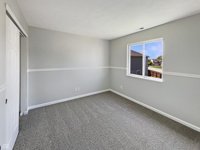 6628 Dunsdin Dr, Plainfield, IN 46168 - unfurnished bedroom with a textured ceiling, visible vents, baseboards, a closet, and carpet flooring
