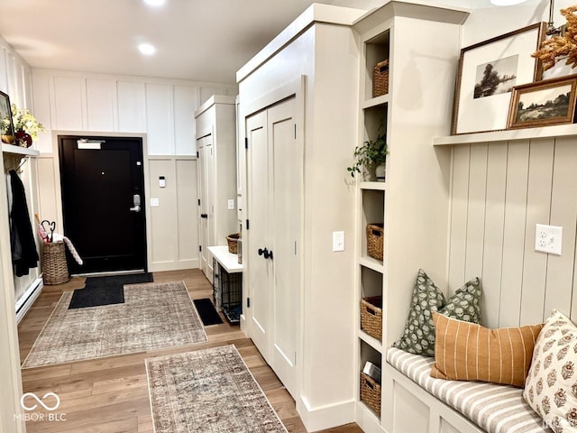 mudroom featuring a baseboard heating unit and light wood-style flooring