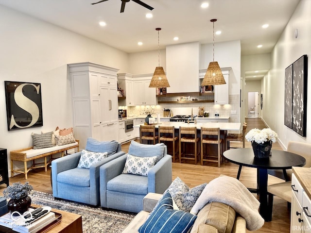 living room featuring recessed lighting, ceiling fan, and light wood-type flooring