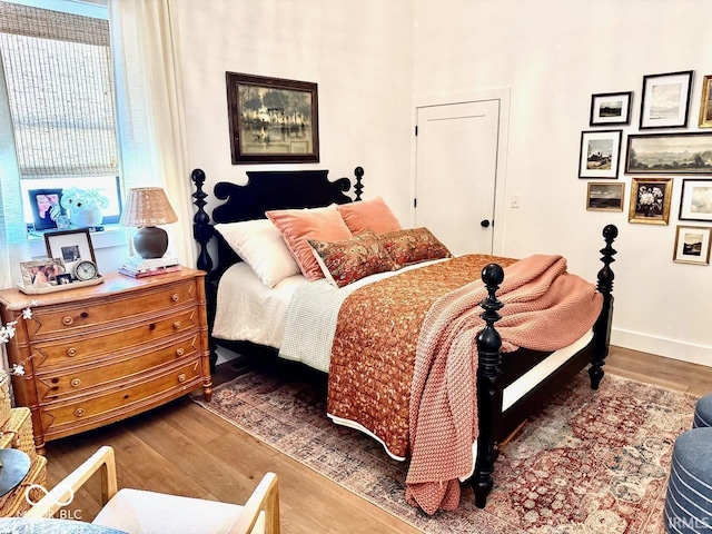 bedroom featuring baseboards and wood finished floors