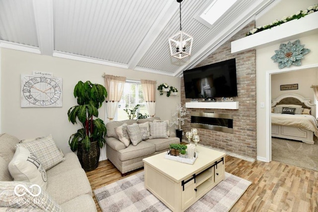 2854 Harlan St, Indianapolis, IN 46203 - living room with a chandelier, light wood-type flooring, and a brick fireplace