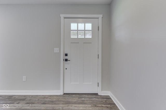 foyer entrance with wood finished floors and baseboards