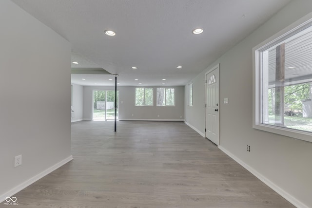 entrance foyer featuring baseboards, recessed lighting, and light wood finished floors
