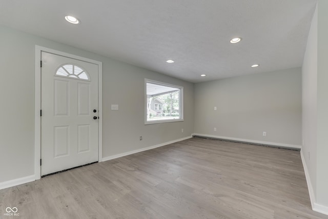 entrance foyer featuring baseboards, recessed lighting, and light wood-style flooring