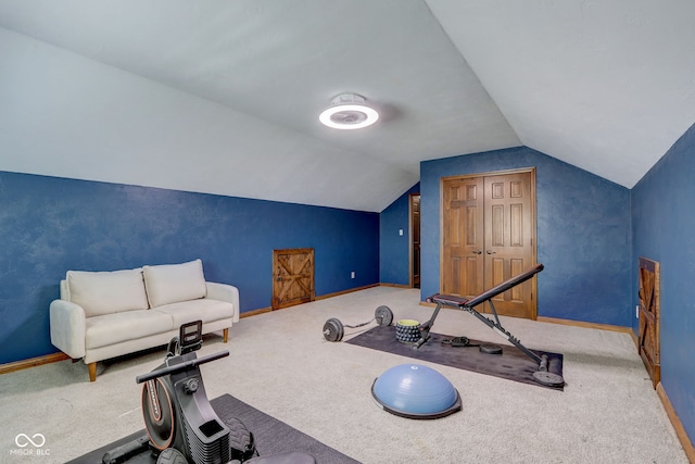workout room with carpet floors, baseboards, and vaulted ceiling