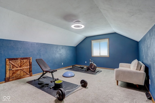 workout room with carpet floors, baseboards, and vaulted ceiling