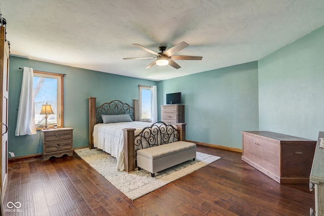 bedroom featuring baseboards, multiple windows, and dark wood finished floors