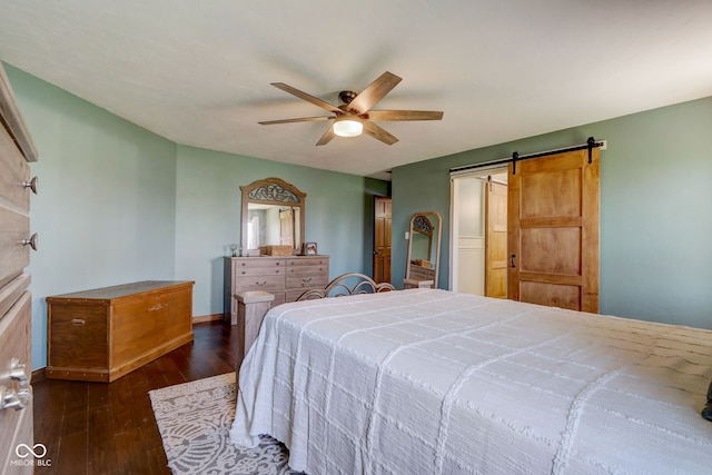 bedroom with baseboards, ceiling fan, hardwood / wood-style flooring, and a barn door