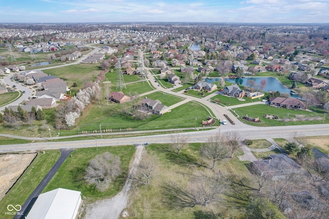 bird's eye view featuring a water view and a residential view