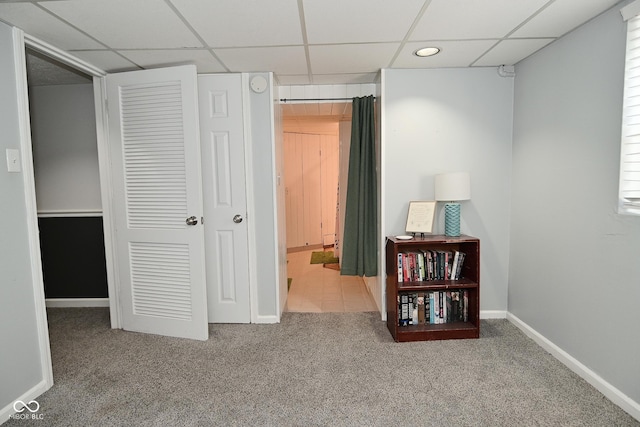 interior space featuring baseboards, recessed lighting, ensuite bathroom, and a drop ceiling