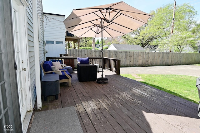 deck with a fenced backyard and outdoor lounge area