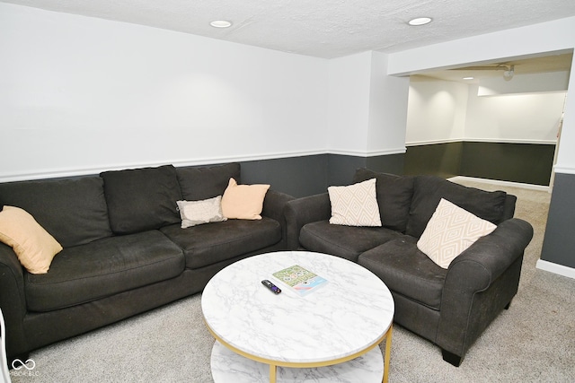 living room featuring baseboards, carpet flooring, recessed lighting, and a textured ceiling