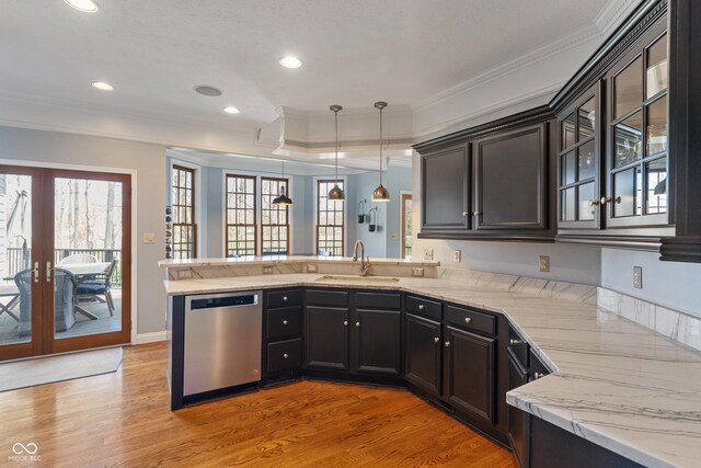 kitchen with stainless steel dishwasher, a sink, a peninsula, and french doors