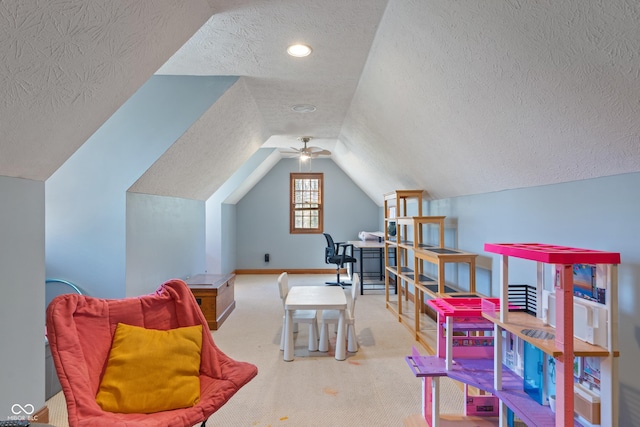 interior space with a textured ceiling, carpet, baseboards, and lofted ceiling