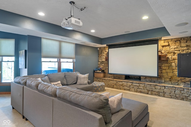 cinema room featuring recessed lighting, carpet, a textured ceiling, and a wealth of natural light