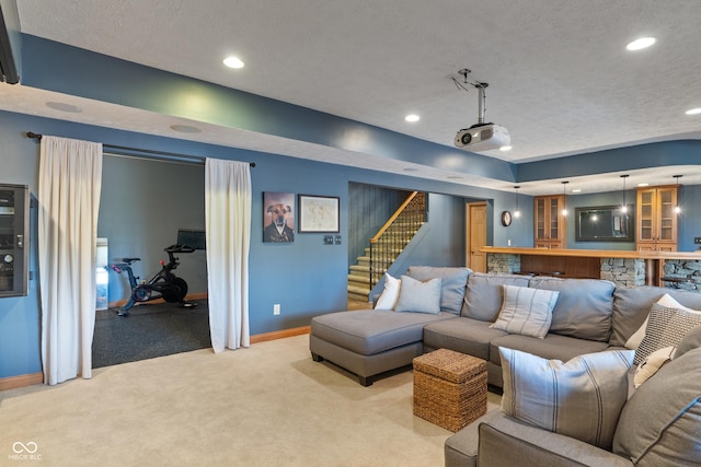 carpeted living area featuring baseboards, recessed lighting, a textured ceiling, and stairway