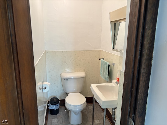 half bath featuring a sink and toilet