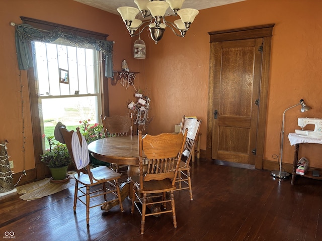 dining space with a chandelier and hardwood / wood-style flooring