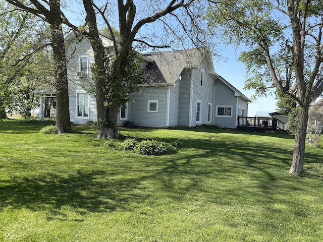 view of side of property featuring a yard and a deck