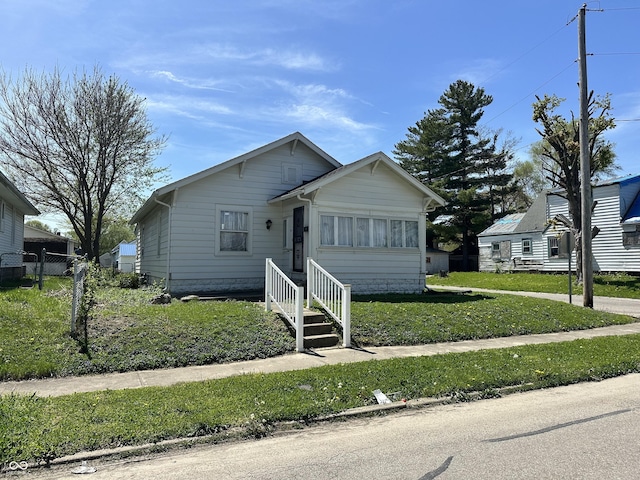 bungalow-style house with a front lawn