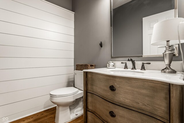 440 E 82nd St, Indianapolis, IN 46240 - bathroom with wood finished floors, toilet, and vanity