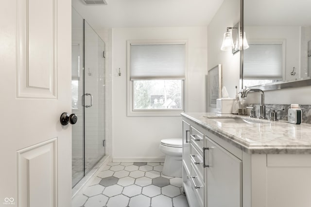 440 E 82nd St, Indianapolis, IN 46240 - bathroom featuring toilet, a shower stall, vanity, tile patterned flooring, and baseboards