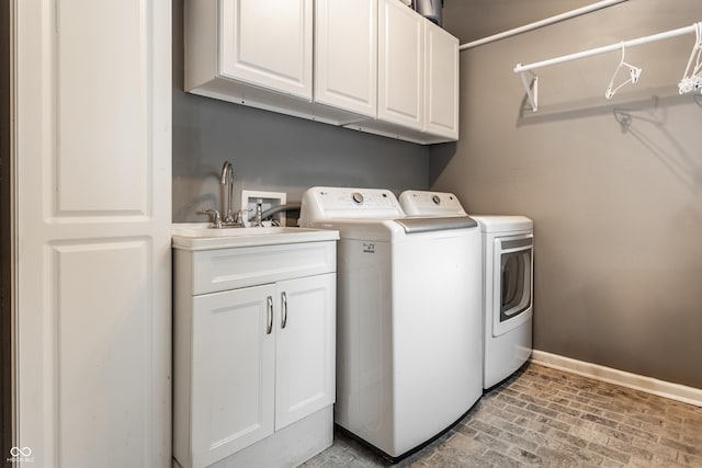 440 E 82nd St, Indianapolis, IN 46240 - laundry room with separate washer and dryer, cabinet space, baseboards, and brick patterned flooring