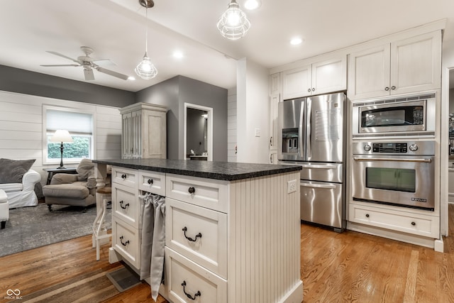 440 E 82nd St, Indianapolis, IN 46240 - kitchen with stainless steel appliances, dark countertops, light wood-type flooring, a ceiling fan, and recessed lighting