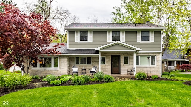 440 E 82nd St, Indianapolis, IN 46240 - traditional-style home featuring stone siding, a front lawn, a shingled roof, and a porch