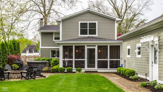 440 E 82nd St, Indianapolis, IN 46240 - rear view of property featuring a sunroom, a fire pit, a hot tub, a chimney, and a shingled roof