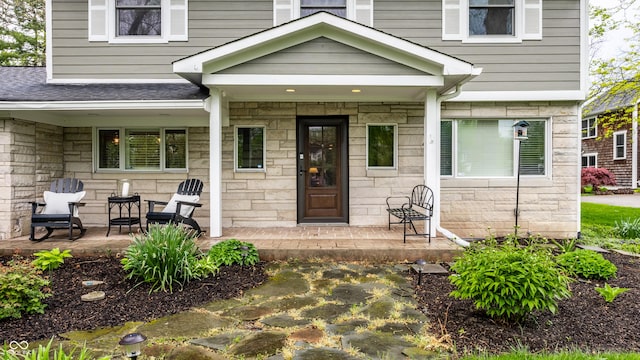 440 E 82nd St, Indianapolis, IN 46240 - property entrance featuring stone siding, roof with shingles, and a porch