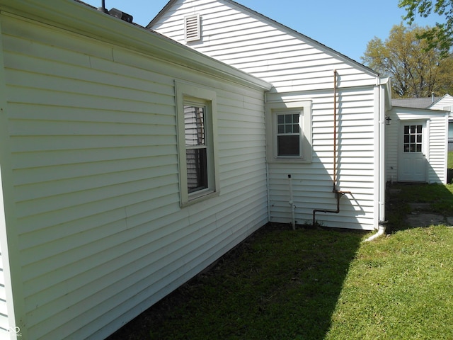 view of side of home featuring a yard