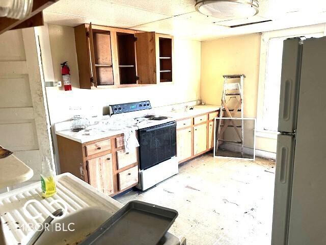 kitchen with freestanding refrigerator and white electric range