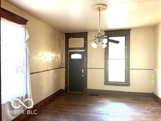 foyer with baseboards, dark wood-style flooring, and ceiling fan