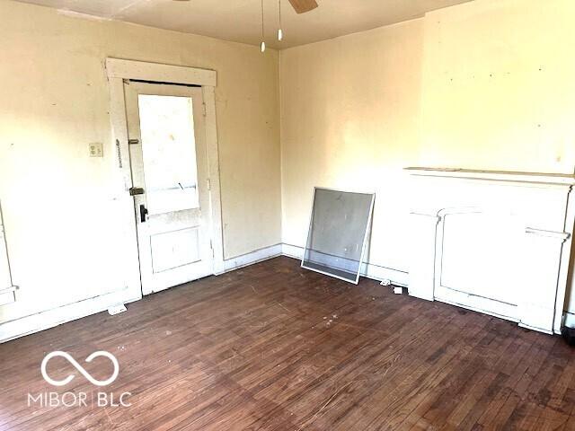 unfurnished room featuring dark wood-style flooring and a ceiling fan