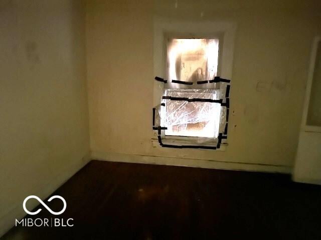 unfurnished room featuring baseboards