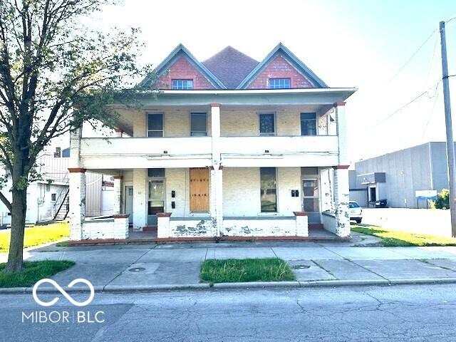 view of front of home with a porch and a balcony