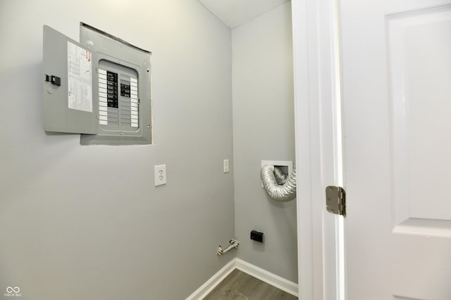 3109 Forest Manor Ave, Indianapolis, IN 46218 - washroom featuring electric panel, laundry area, hookup for a gas dryer, wood finished floors, and baseboards