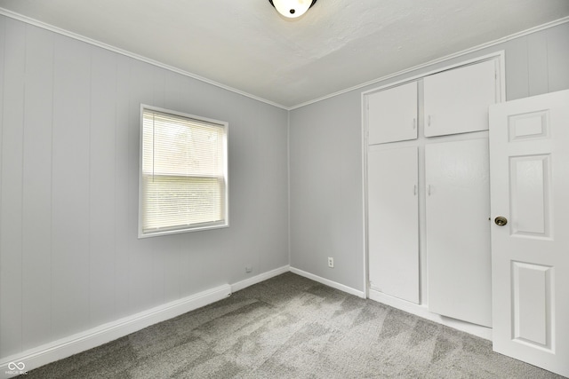 3109 Forest Manor Ave, Indianapolis, IN 46218 - unfurnished bedroom featuring crown molding, baseboards, and carpet floors