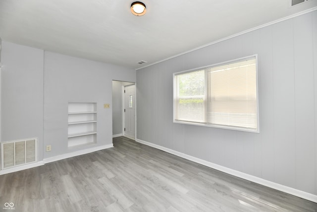 3109 Forest Manor Ave, Indianapolis, IN 46218 - spare room with visible vents, baseboards, built in features, and wood finished floors