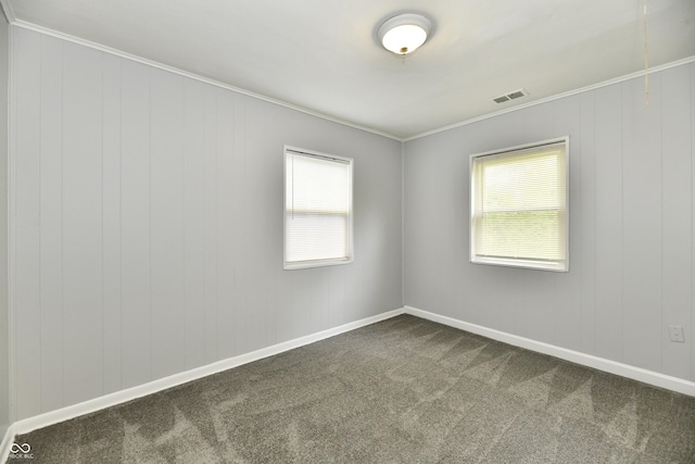 3109 Forest Manor Ave, Indianapolis, IN 46218 - empty room featuring crown molding, visible vents, a wealth of natural light, and dark carpet