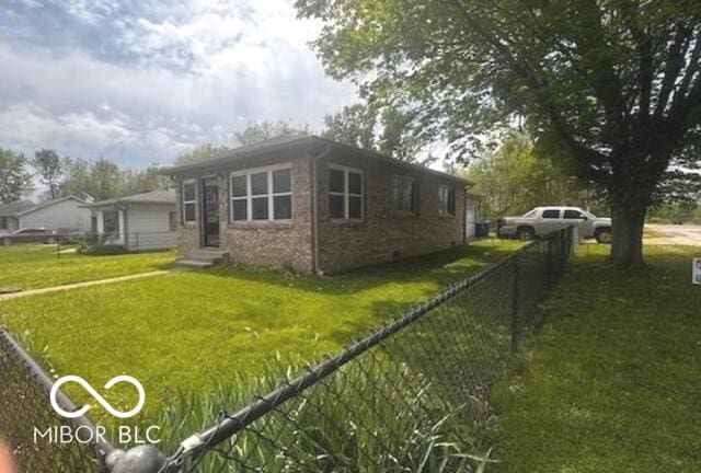 view of side of home with entry steps, a yard, and fence private yard