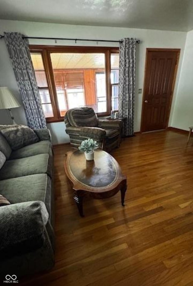 living area featuring baseboards and wood finished floors
