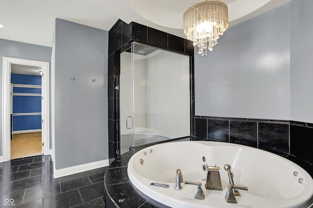 full bathroom with tile patterned flooring, a jetted tub, baseboards, a stall shower, and a notable chandelier