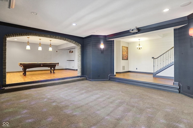 playroom with arched walkways, baseboards, ornamental molding, and carpet floors