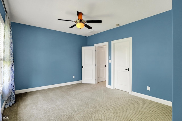 unfurnished bedroom featuring baseboards, ceiling fan, and carpet