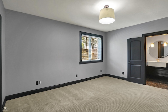 unfurnished bedroom featuring carpet flooring and baseboards